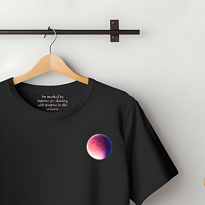 100% Organic Cotton Black t-shirt featuring a super-large bold, super-large graphic on the chest of a Purple Moon.Inside the collar, the text reads "I'm marked by impacts yet shining with purpose in the universe"